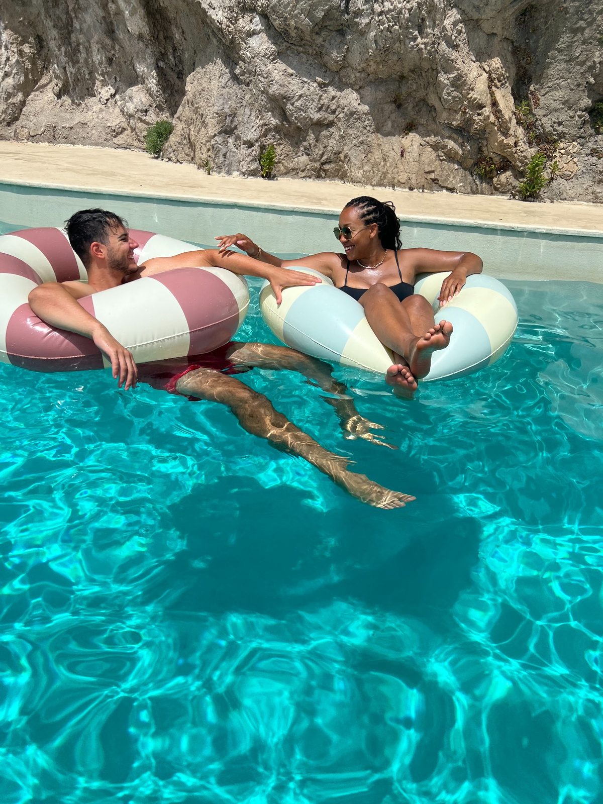 Roberto and Alexis relaxing in a pool