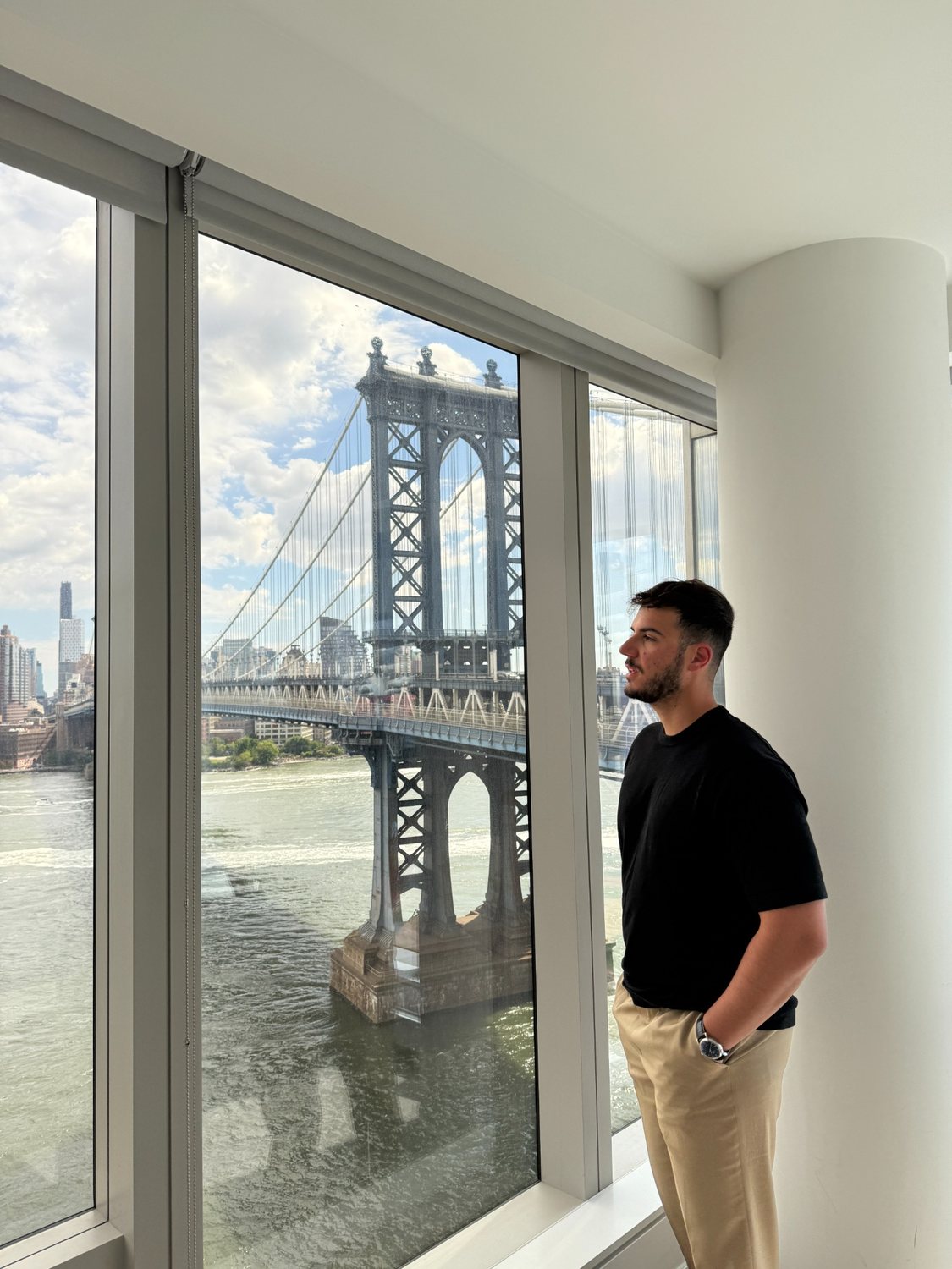 Roberto looking out over New York from an apartment view